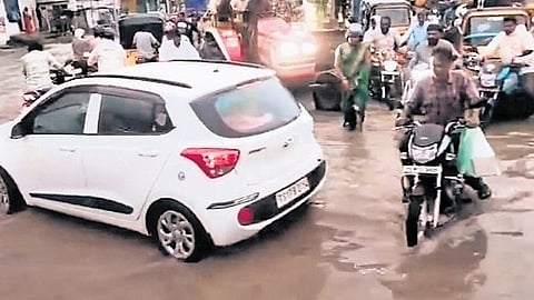 Motorists struggle to navigate an inundated road in Kamareddy on Thursday.