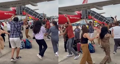 Indian tourists performing garba at a Vietnam airport tarmac