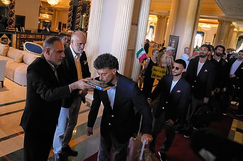 Iran's players kiss the Muslim's holiest book Quran as they leave to Antalya airport, southern Turkey, Saturday, June 6, 2026, before departing to Tijuana, Mexico, for the World Cup soccer tournament. 