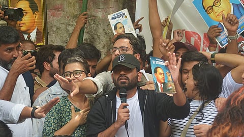 Cockroach Janta Party (CJP) founder Abhijeet Dipke (C) addresses the gathering during a protest demanding the resignation of Union Education Minister Dharmendra Pradhan over alleged examination-related lapses at the Jantar Mantar in New Delhi, Saturday, June 6, 2026.