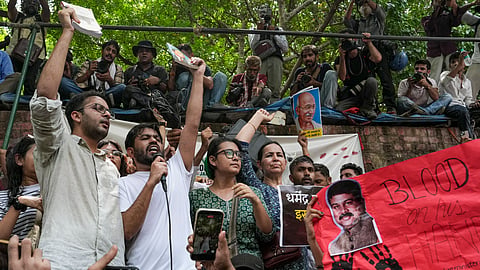 Cockroach Janta Party's (CJP) founder Abhijeet Dipke, in white, spokesperson Ashutosh Ranka, left, and others raise slogans during a protest demanding the resignation of Union Education Minister Dharmendra Pradhan over alleged examination-related lapses, at the Jantar Mantar, in New Delhi, Saturday, June 6, 2026.