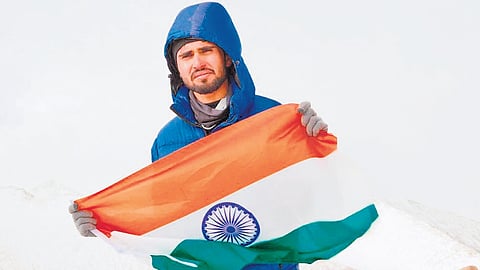Bhukya Yashwanth poses with the national flag after climbing an unnamed peak (6,037 m).
