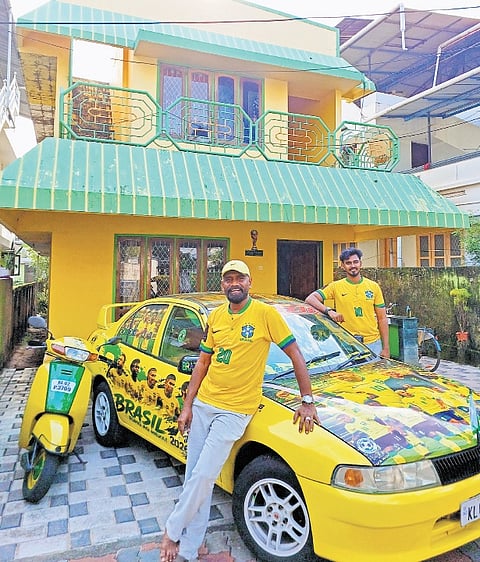  Sudheer and his son Alim S in front of their residence at Pallimukku in Kollam, surrounded by Brazil-themed decorations, including a customised car and scooter adorned with images of Brazilian football stars 