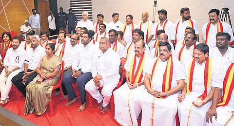 The newly-inducted party members with TVK general secretary and Minister N Anand in Chennai on Saturday.