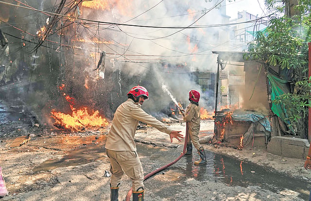 Firefighters dousing fire in the Malviya Nagar hotel on Wednesday (from top), The neglected lanes of Khirki Extension, The sealed establishment after the incident 