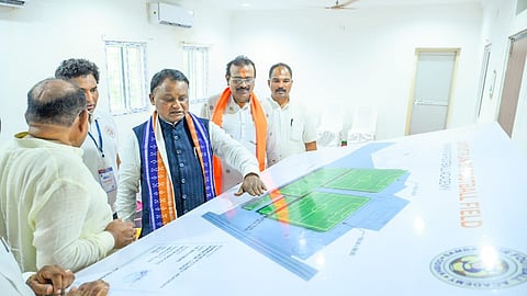 CM Mohan Charan Majhi going through the plan of the new football field in Sambalpur.