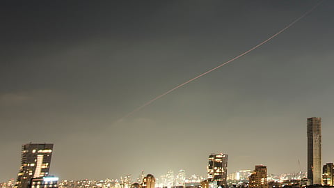 A projectile streaks through the sky over central Israel during an Iranian missile attack, Sunday, June 7, 2026.