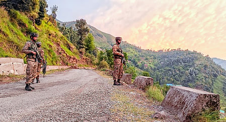 Security personnel stand guard in the Gambhir Mughalan-Dori Maal area of Rajouri district, Jammu and Kashmir.