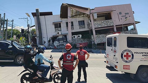 In this photo provided by the Philippine Red Cross, rescuers inspect the damage after an earthquake in General Santos, Philippines, Monday, June 8, 2026.