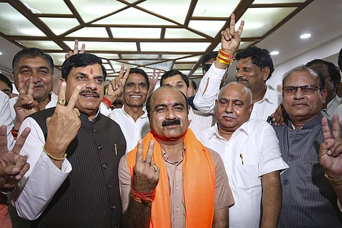 Madhya Pradesh Chief Minister Mohan Yadav, state BJP President Hemant Khandelwal and party candidate Mahesh Kewat and others show victory signs