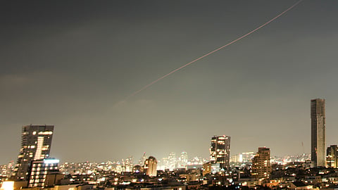 A projectile streaks through the sky over central Israel during an Iranian missile attack, Sunday, June 7, 2026.