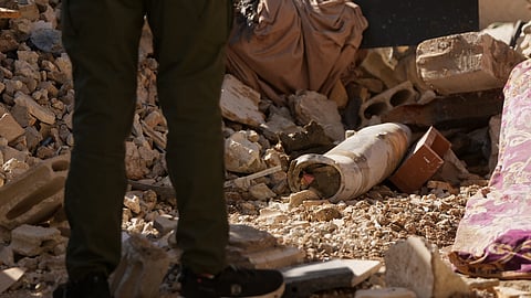 A man stands next to an unexploded missile at the site where an Israeli airstrike hit a building in Dahiyeh, Beirut's southern suburb, Lebanon, Sunday, June 7, 2026.
