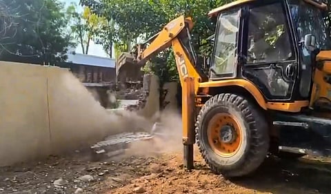Authorities carry out a demolition drive against an alleged illegal construction in the Sainik Farms area, in New Delhi, Sunday, June 7, 2026. 