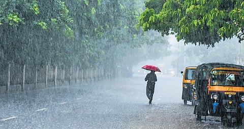 A man walks on a road as a thunderstorm lashes Bhubaneswar on Sunday 