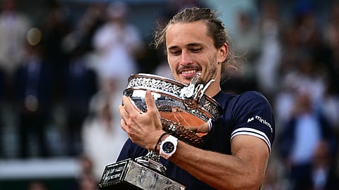 Germany's Alexander Zverev holds "La Coupe des Mousquetaires" trophy after winning the French Open tennis tournament men's singles final match against Italy's Flavio Cobolli in Paris on June 7, 2026.