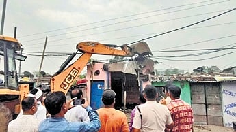 The demolition drive underway at Meenapada slum in Rourkela on Monday.