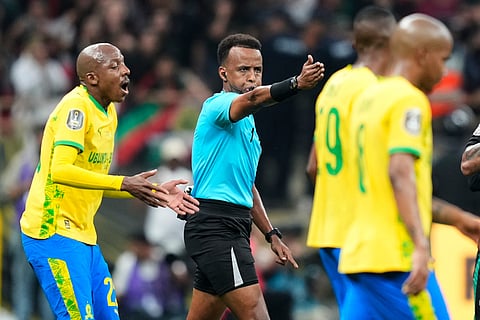 Referee Omar Artan, center, signals a penalty during the CAF Champions League final soccer match between AS FAR Rabat and Mamelodi Sundowns.