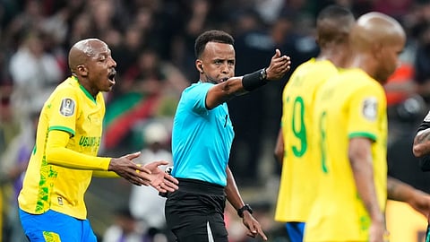 Referee Omar Artan, center, signals a penalty during the CAF Champions League final soccer match between AS FAR Rabat and Mamelodi Sundowns, in Rabat, Morocco, Sunday, May 24, 2026. 