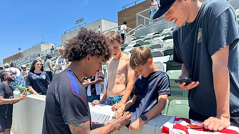 United States defender Chris Richards, front left, gives autographs to fans after the national team's first practice at its World Cup soccer tournament training base in Irvine, Calif., Monday, June 8, 2026.