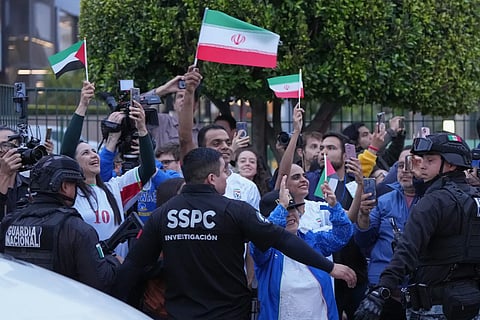Fans for team Iran wave as players arrive for the World Cup soccer tournament in Tijuana, Mexico, Sunday, June 7, 2026.
