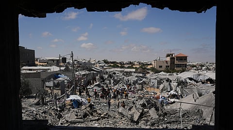 Palestinians inspect the rubble of a building destroyed in an Israeli airstrike at Khan Younis, in the southern Gaza Strip, Sunday, June 7, 2026.