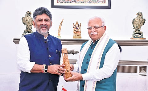 Chief Minister DK Shivakumar greets Union Housing and Urban Affairs Minister Manohar Lal Khattar in New Delhi on Wednesday.