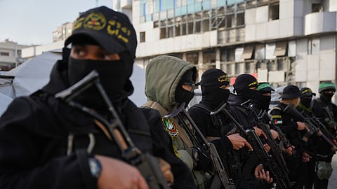 Armed Palestinian militants from Hamas and Islamic Jihad gather next to Eid al-Fitr prayers in Gaza City, March 20, 2026.