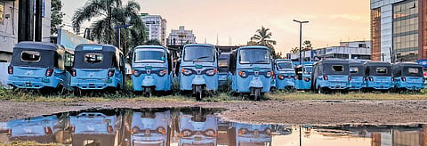 Defunct e-autorickshaws owned by the Ernakulam District Autorickshaw Drivers Cooperative Society illegally parked at Kaloor Metro Station parking area