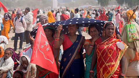 Women taking shelter while attending a election rally