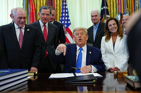 President Donald Trump gets ready to sign a bill funding immigration enforcement in the Oval Office of the White House, Wednesday, June 10, 2026, in Washington. 
