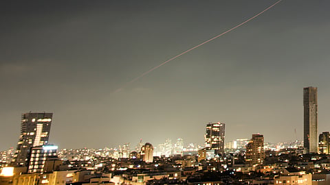 A projectile streaks through the sky over central Israel during an Iranian missile attack, Sunday, June 7, 2026