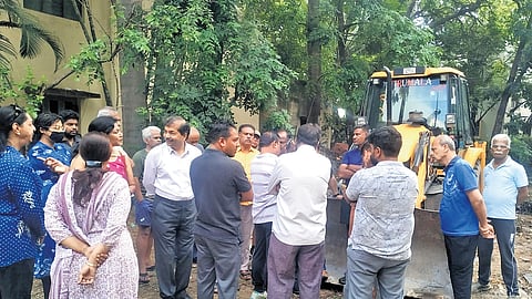 Residents stop an earthmover from carrying out digging work for a Waste Transfer Station on a park land in Kasturinagar on Friday 