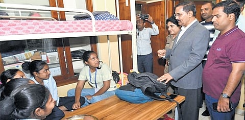 Upa Lokayukta Justice B Veerappa interacts with students at Social Welfare Department hostel in Mandya during his surprise visit 