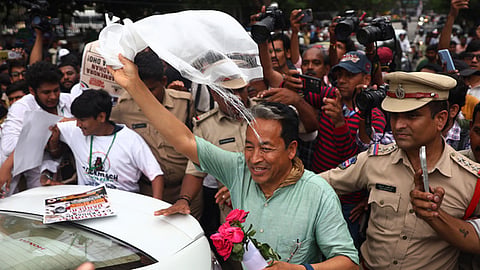Activist Sonam Wangchuk waves at the supporters of the Cockroach Janta Party (CJP) as he participates in a protest in Hyderabad.