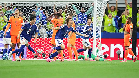 Japan's Koki Ogawa (19) and Takehiro Tomiyasu (22) celebrate their side's second goal against the Netherlands during a World Cup Group F soccer match in Arlington, Texas, near Dallas, Sunday, June 14, 2026. 