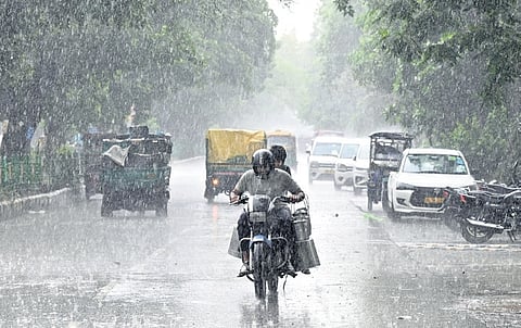 Commuters navigate roads amid rainfall on Monday 