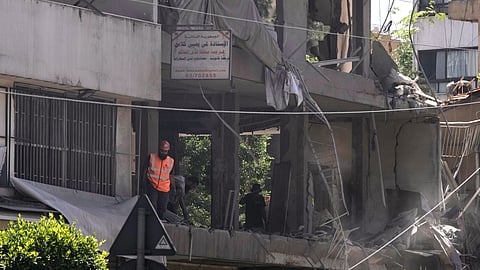 A rescue worker checks an apartment that was hit in an Israeli airstrike in Dahiyeh, Beirut's southern suburbs, Lebanon, Sunday, June 14, 2026.