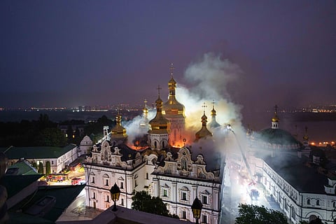 Rescue workers try to put out a fire at the Dormition Cathedral of thousand-year-old Monastery of Caves, also known as Kyiv Pechersk Lavra, following a Russian strike on Kyiv, Ukraine, Monday, June 15, 2026.