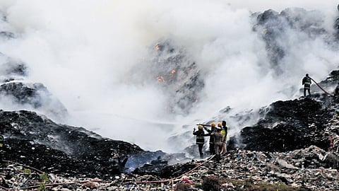 Firefighters dousing the blaze at Perungudi dumpyard on Monday.