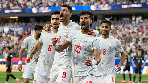 Iran's Ramin Rezaeian (23) celebrates with his teammates after scoring a goal during the World Cup