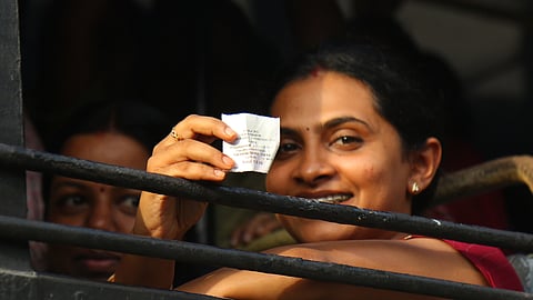 A woman displays her zero-fare ticket issued under the free travel scheme at Ernakulam Jetty in Kochi on Monday 