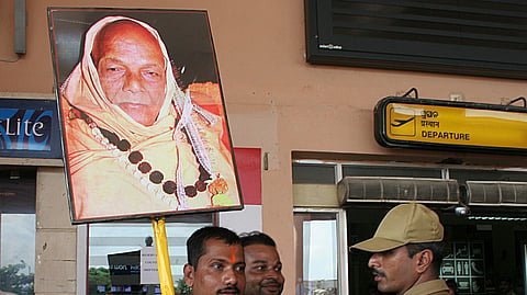 BHUBANESWAR: An activist holds cutout of senior Vishwa Hindu Parishad leader Swami Lakshmanananda Saraswati to receive International General Secretary of VHP Pravin Togadia at the Biju Patnaik Airport in Bhubaneswar - Express Photo by Shamim. (2008)
