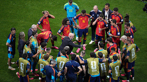 Spain head coach Luis de la Fuente talks with players during a hydration break in the World Cup Group H soccer match between Spain and Cape Verde in Atlanta, Monday, June 15, 2026. 