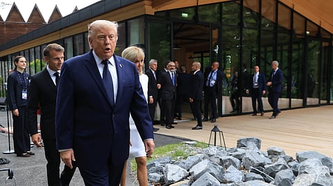 U.S. President Donald Trump walks after posing for a family photo photograph during a gala dinner as part of the G7 summit, in Evian-les-Bains, France, Tuesday June 16, 2026.