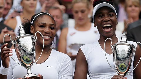 Serena Williams, left, and Venus Williams of the U.S hold their trophies after winning the women's doubles final against Yaroslava Shvedova of Kazahkstan and Timea Babos of Hungary.