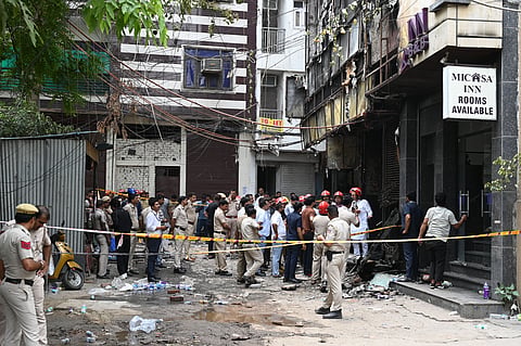 Police and Fire Brigade personnel at the site where a fire broke out in a restaurant at Malviya Nagar, in New Delhi earlier this month.