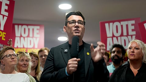 Andy Burnham delivers a speech at St Jude's ARLFC, in Wigan, England, Saturday June 13, 2026, as he campaigns ahead of the Makerfield by-election.