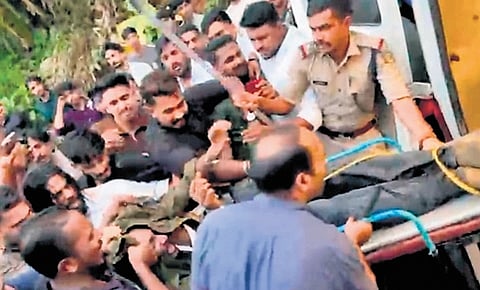 A video grab shows Ajmal being moved to ambulance after being tied up