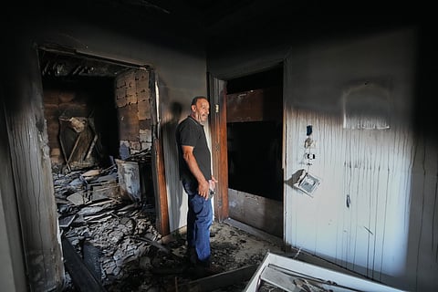 Resident Samih Haidar reacts as he inspects his burned apartment damaged in Israeli strikes in the southern port city of Tyre, Lebanon, Thursday, June 18, 2026. 