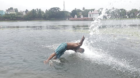 A youth dive into the holy tank of Bindu Sagar, seeking relief from the scorching heat in Bhubaneswar on Wednesday.